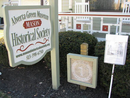 Historical marker at the Alverta Green Museum and printed guides to the Mason Historical Tour